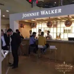 Scene at Johnnie Walker House Buenos Aires with live Blue Label bottle engraving by Eli Moreno and Green Glass recycled glassware display