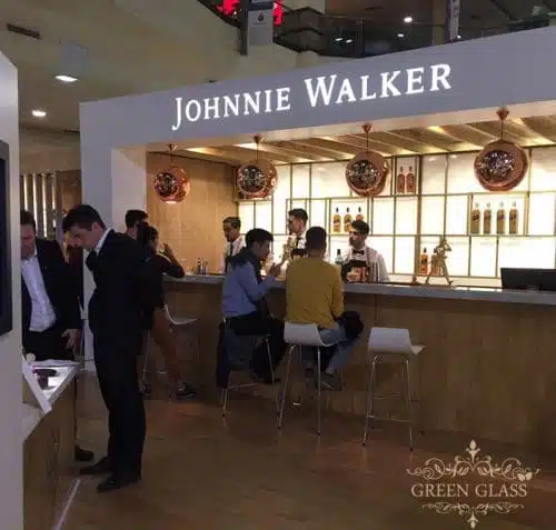 Scene at Johnnie Walker House Buenos Aires with live Blue Label bottle engraving by Eli Moreno and Green Glass recycled glassware display
